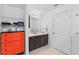 Modern bathroom featuring dark brown cabinets, white countertop, and a pop of color with an orange dresser at 1102 Wynnmere Walk Ave, Ruskin, FL 33570