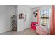 A room with pink accents, a window, and bright storage at 1102 Wynnmere Walk Ave, Ruskin, FL 33570