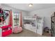 Bright and colorful ' bedroom with a bunk bed, pink beanbag chair, and natural light at 1102 Wynnmere Walk Ave, Ruskin, FL 33570