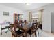 Formal dining room featuring a large wood table, seating for six, and decorative cabinet at 1102 Wynnmere Walk Ave, Ruskin, FL 33570