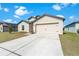 Attractive single-Gathering home features a neutral color scheme, a two-car garage, and a well-maintained front lawn at 1102 Wynnmere Walk Ave, Ruskin, FL 33570