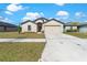 Charming single-story home with a neutral color scheme, well-manicured lawn, and a two-car garage at 1102 Wynnmere Walk Ave, Ruskin, FL 33570