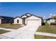 Well-maintained single-Gathering home with a two-car garage, landscaping, and a long driveway at 1102 Wynnmere Walk Ave, Ruskin, FL 33570