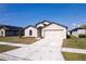 Attractive single-Gathering home with a manicured lawn, a two-car garage, and a paved driveway at 1102 Wynnmere Walk Ave, Ruskin, FL 33570