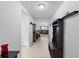 Inviting hallway with tile flooring, coat rack, and views to the living spaces at 1102 Wynnmere Walk Ave, Ruskin, FL 33570