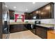 Stylish kitchen features granite counters, dark cabinetry, and updated appliances for a modern feel at 1102 Wynnmere Walk Ave, Ruskin, FL 33570