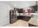 Kitchen featuring dark cabinets, stainless steel appliances, and granite countertops at 1102 Wynnmere Walk Ave, Ruskin, FL 33570