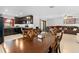 An open concept dining area, kitchen with dark cabinetry, and a living space with leather couches at 1102 Wynnmere Walk Ave, Ruskin, FL 33570