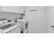 Bright laundry room with white appliances and ample storage space for convenience at 1102 Wynnmere Walk Ave, Ruskin, FL 33570