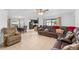 Open-concept living room with dining area featuring tiled floors and comfortable seating arrangement at 1102 Wynnmere Walk Ave, Ruskin, FL 33570