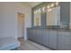 Modern bathroom with dual sinks, sleek gray cabinetry, and a spacious feel at 1150 7Th Ne Ave, Largo, FL 33770