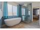 Bathroom features a modern tub, walk-in shower, and sleek fixtures at 1150 7Th Ne Ave, Largo, FL 33770