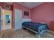 Bedroom with warm pink tones and a cozy rug at 1150 7Th Ne Ave, Largo, FL 33770