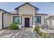 Inviting front entrance with tiled walkway, front bench, and manicured landscaping at 1150 7Th Ne Ave, Largo, FL 33770