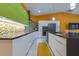 Spacious kitchen featuring sleek cabinetry, stainless appliances, and tiled backsplash at 1150 7Th Ne Ave, Largo, FL 33770