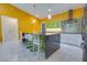 Modern kitchen features stylish cabinets, updated appliances, and an island with seating for four at 1150 7Th Ne Ave, Largo, FL 33770