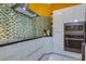 Bright kitchen featuring modern appliances, eye-catching backsplash, and white cabinets at 1150 7Th Ne Ave, Largo, FL 33770