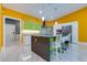 Bright kitchen with a large island, modern appliances, unique backsplash, and sleek cabinetry at 1150 7Th Ne Ave, Largo, FL 33770