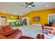 Open-concept living room with hardwood floors and bright yellow accent wall at 1150 7Th Ne Ave, Largo, FL 33770