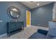 Modern sitting room boasts a stylish grey theme with a blue loveseat and white marble floors at 1150 7Th Ne Ave, Largo, FL 33770