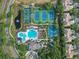 A stunning aerial view showcases the community pool, tennis courts, and lush landscaping at 11644 Meridian Point Dr, Tampa, FL 33626