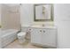 Neutral bathroom with tub, toilet, and vanity with white cabinets and hardware at 11644 Meridian Point Dr, Tampa, FL 33626