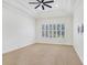 Neutral bedroom featuring tray ceiling, carpet, a window with shutter-style blinds, and a fan at 11644 Meridian Point Dr, Tampa, FL 33626