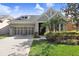Charming single-Gathering home with manicured lawn, three-car garage, and appealing stone and stucco facade at 11644 Meridian Point Dr, Tampa, FL 33626