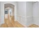 Bright hallway featuring wainscoting, light hardwood floors, and an arched doorway leading to the living area at 11644 Meridian Point Dr, Tampa, FL 33626