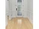 Elegant hallway with decorative trim and a glass-accented front door, leading into the home at 11644 Meridian Point Dr, Tampa, FL 33626