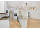Updated kitchen with white cabinets, granite countertops, stainless appliances, hardwood floors, and island sink at 11644 Meridian Point Dr, Tampa, FL 33626