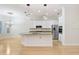 Modern kitchen with granite countertops, stainless steel appliances, white cabinetry, and hardwood flooring at 11644 Meridian Point Dr, Tampa, FL 33626