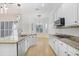 Bright eat-in kitchen featuring white cabinets, granite counters, stainless appliances, and wood floors at 11644 Meridian Point Dr, Tampa, FL 33626