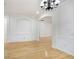 Open-concept living room featuring hardwood floors, white walls, white trim, crown molding, and arched entryways at 11644 Meridian Point Dr, Tampa, FL 33626