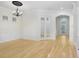 Bright living room with hardwood floors, crown molding, chandelier, and entrance to foyer and other rooms at 11644 Meridian Point Dr, Tampa, FL 33626