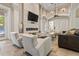 Bright living room with stylish fireplace, large TV, and comfortable seating, creating an inviting community space at 11644 Meridian Point Dr, Tampa, FL 33626