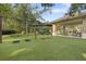 Outdoor playground with swings and climbing structure on an artificial turf at 11644 Meridian Point Dr, Tampa, FL 33626