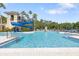 A luxurious pool with water slides and ample lounge seating offers relaxation and recreation at 11644 Meridian Point Dr, Tampa, FL 33626