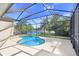 Screened pool with lake view offers a relaxing backyard oasis for tranquil outdoor living and entertaining at 11644 Meridian Point Dr, Tampa, FL 33626