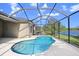 Inviting screened-in pool area features a kidney-shaped pool and beautiful lake views at 11644 Meridian Point Dr, Tampa, FL 33626