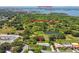 Aerial view of the home with lush greenery and a pond. Conveniently located near the Gulf of Mexico at 12020 66Th Ave, Seminole, FL 33772