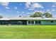 Green backyard features a well-manicured lawn extending from the house to the fence line at 12020 66Th Ave, Seminole, FL 33772