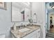 Updated vanity with granite countertop and framed mirror at 12020 66Th Ave, Seminole, FL 33772