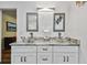 Elegant bathroom features double glass bowl sinks, granite countertops, and modern lighting at 12020 66Th Ave, Seminole, FL 33772