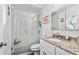 Modern bathroom with granite countertop, glass shower, and decorative tile at 12020 66Th Ave, Seminole, FL 33772