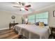 Bedroom with twin beds, wood floors, ceiling fan, and desk at 12020 66Th Ave, Seminole, FL 33772