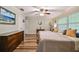 Bedroom with twin beds, wood floors, ceiling fan, and dresser at 12020 66Th Ave, Seminole, FL 33772