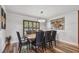 Dining room boasts hardwood floors, modern lighting, and plenty of seating at 12020 66Th Ave, Seminole, FL 33772