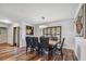 Elegant dining room with hardwood floors, modern lighting, and dark wood accents at 12020 66Th Ave, Seminole, FL 33772