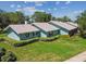 Charming single-story home with a well-manicured lawn and light blue exterior at 12020 66Th Ave, Seminole, FL 33772